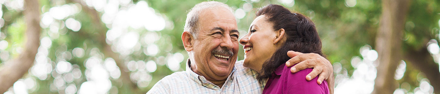 Senior couple hugging outside